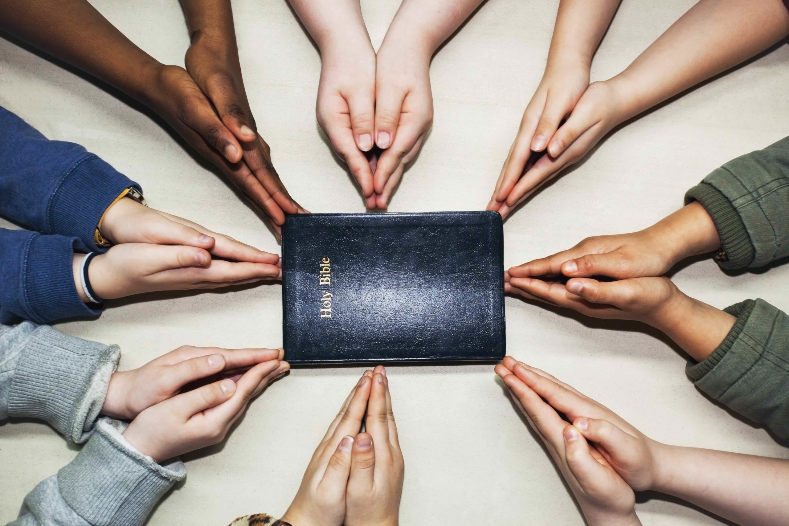Picture of Multicultural hands around bible scaled in the page Inclusive workshop - enabling cultural gifts